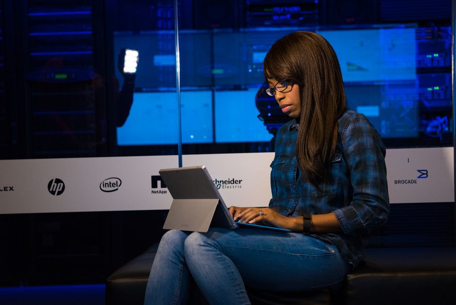Žena intenzivno radi na laptopu u modernom podatkovnom centru